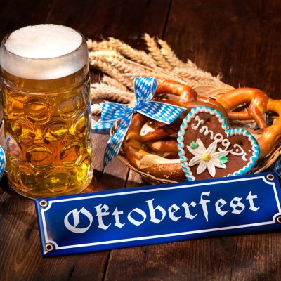 Original bavarian pretzels with beer stein on wooden board. Oktoberfest background